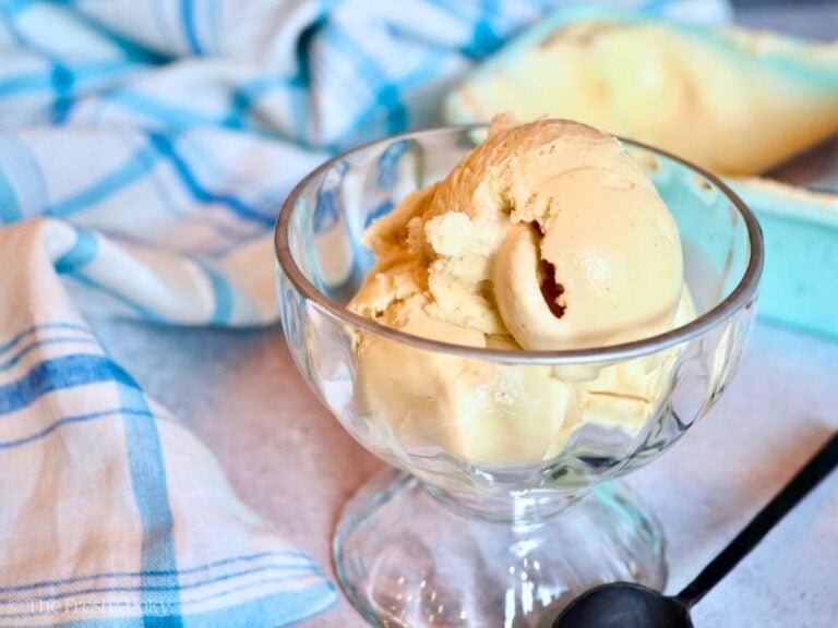 Several scoops of creamy vanilla ice cream in a pretty ice cream bowl.