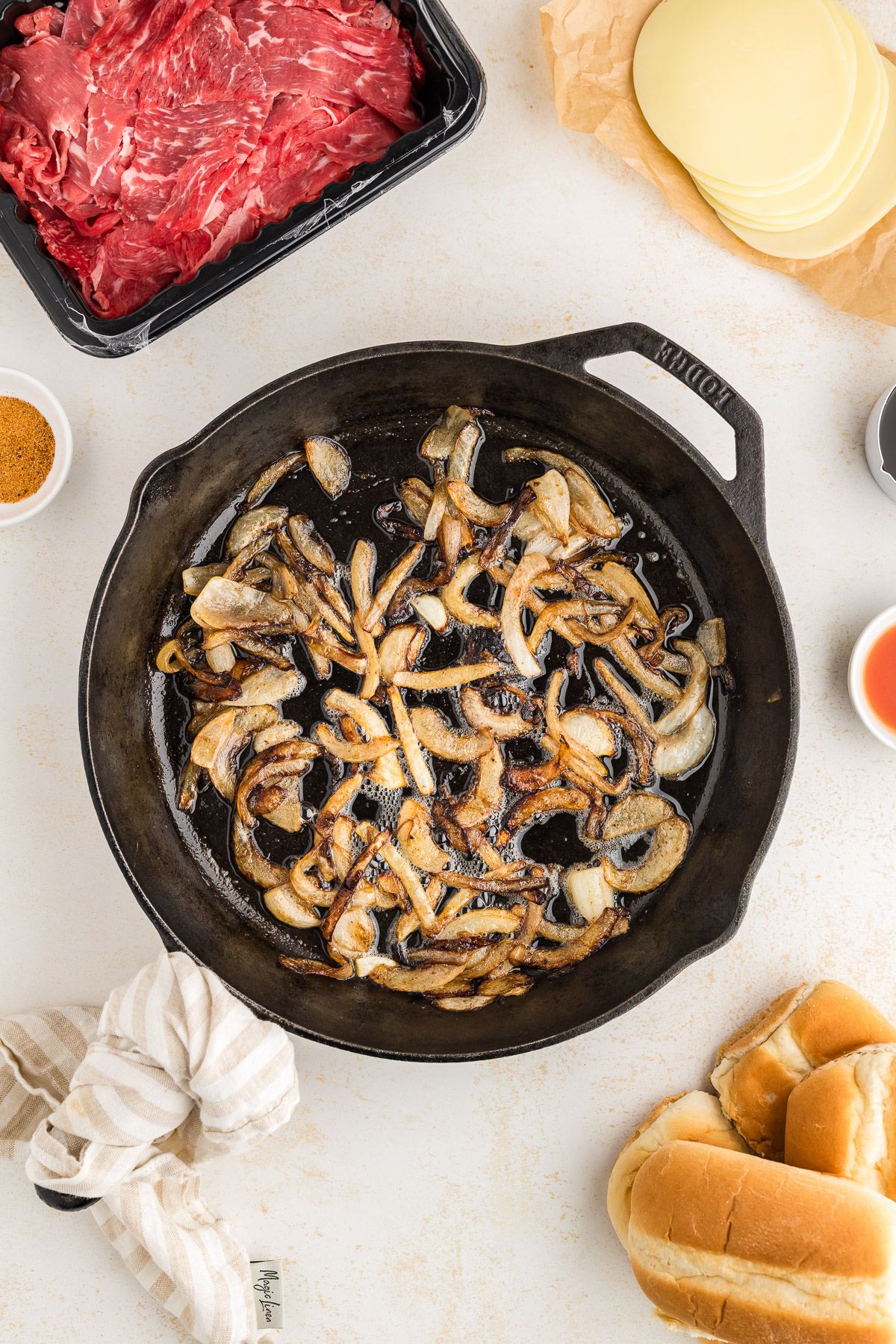 Onions sautéing and caramelizing in cast iron skillet.