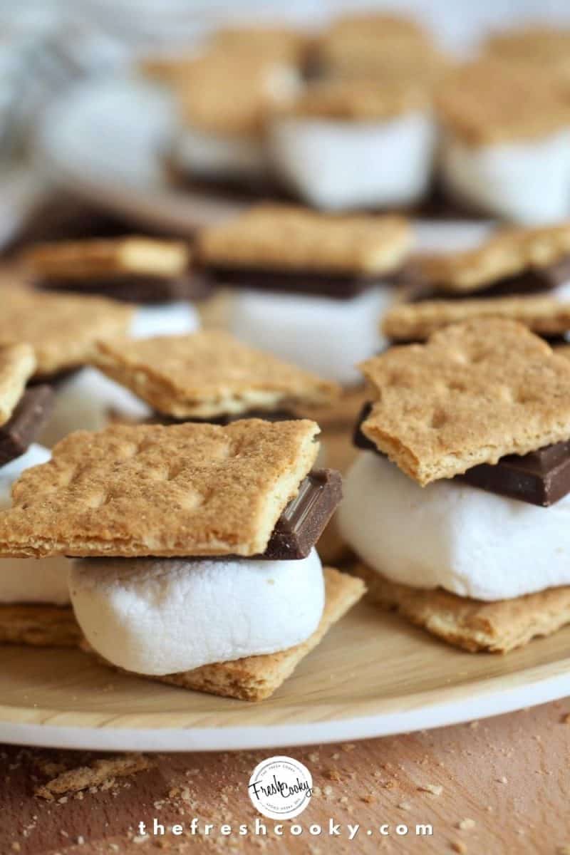 mini s'more stacks for stuffing, square of graham crackers sandwiching a ½ marshmallow and a hunk of chocolate, sitting on a plate.