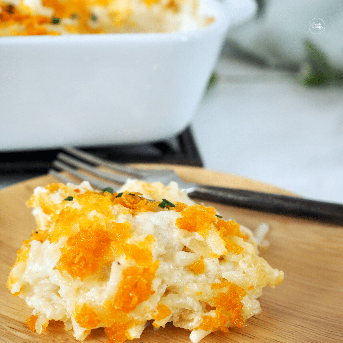 Cheesy hashbrown casserole recipe with corn flake topping.