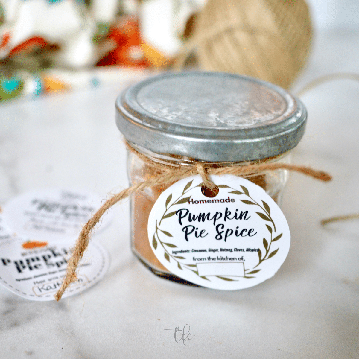 Square image of pumpkin pie spice substitute in a jar with a pretty gift tag.