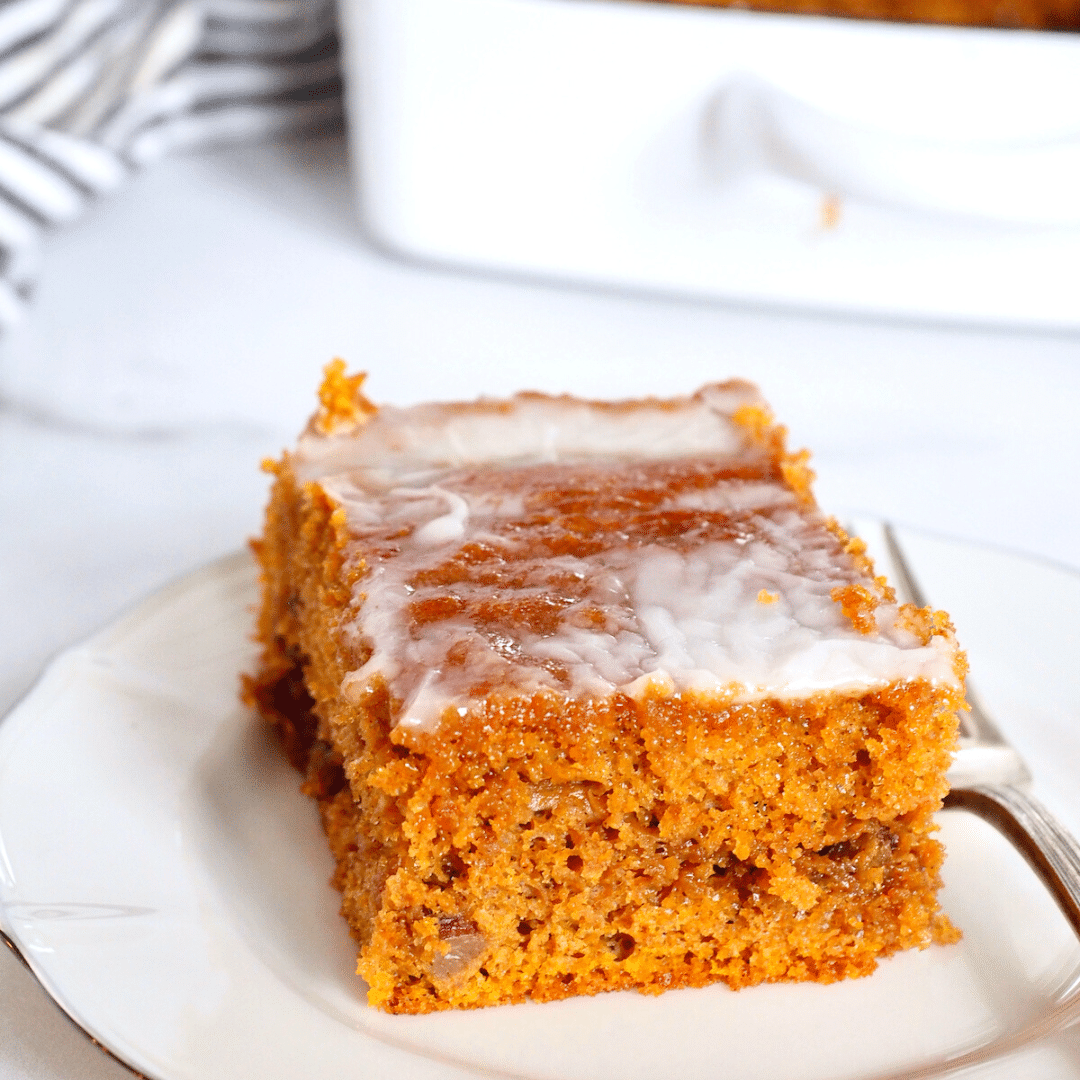 Slice of pumpkin coffee cake on a pretty plate with fork.