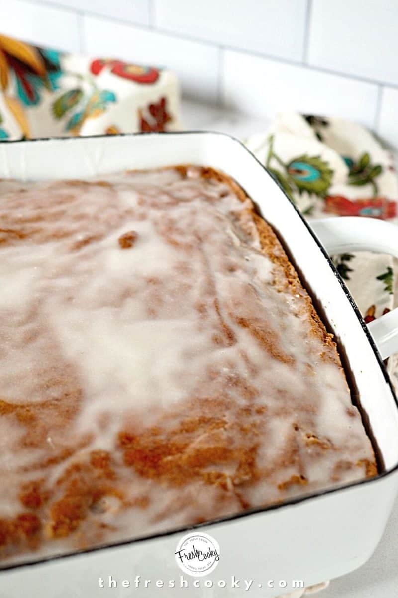 Pumpkin Spice Cake with glaze in white baking dish