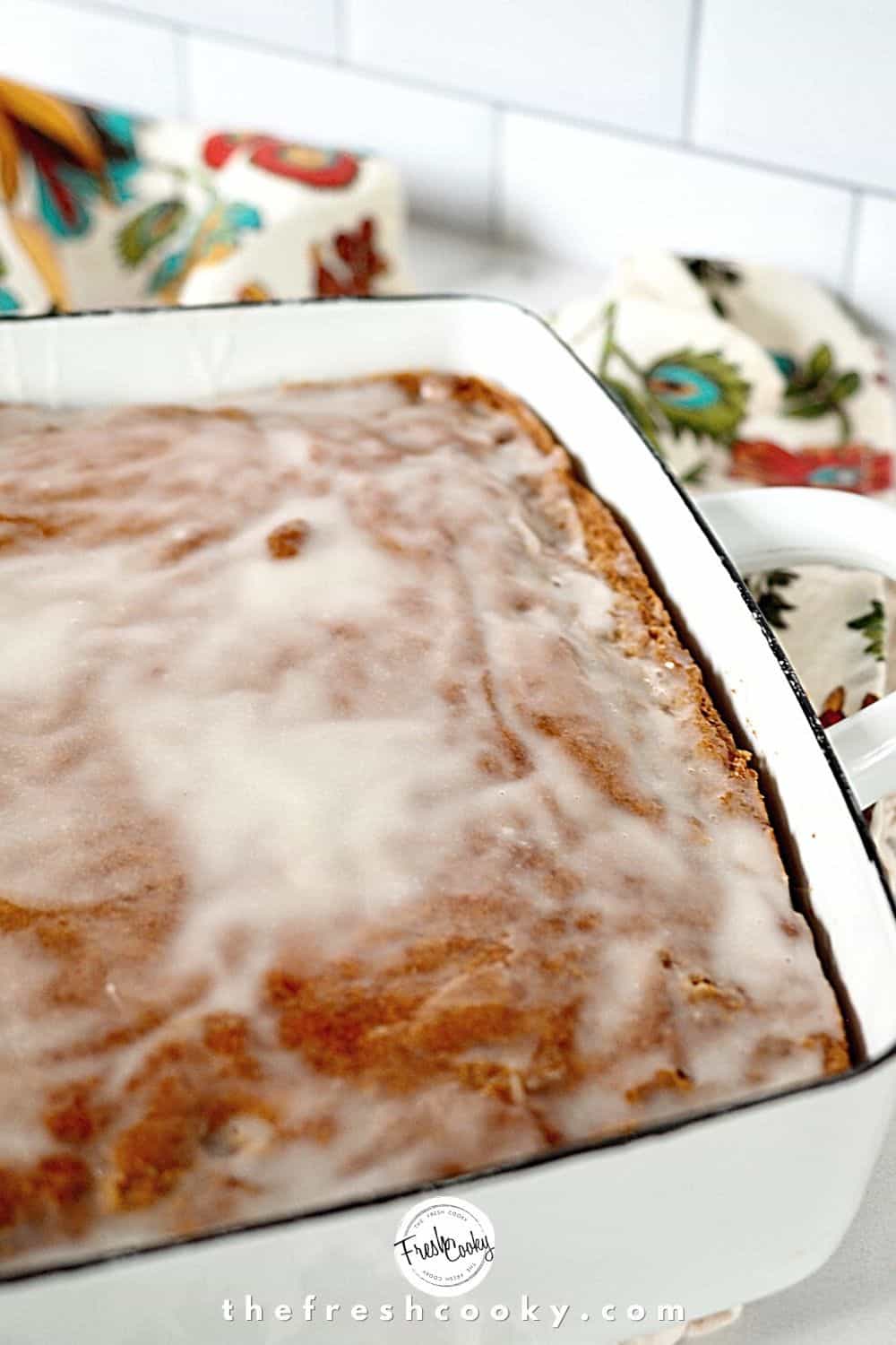 Pumpkin Spice Cake with glaze in white baking dish.