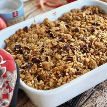How from the oven, a serving dish with apple crisp.