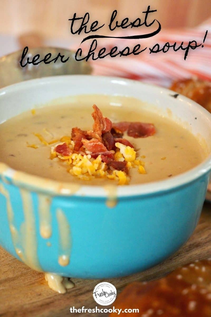 Pinterest Image with writing saying the Best Beer Cheese Soup! Turquoise bowl filled with Beer Cheese soup (some dripping off the edges) with shredded cheese and crumbled bacon on top.