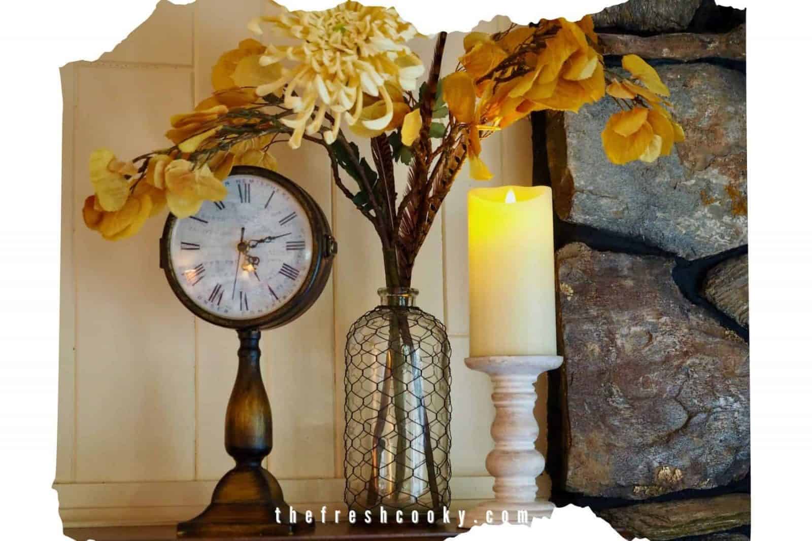Fall-mantle with old time clock, glas vase witth aspen leaves, giantt mum and rustic candlestick with pillar candle