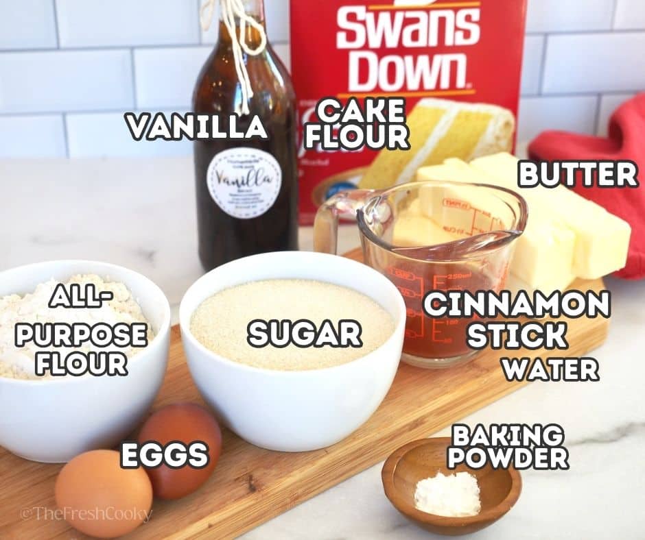 Ingredient shot for Koulourakia cookies. Left to right vanilla, cake flour, butter, cinnamon reduction, baking powder, cane sugar, all purpose flour, vanilla and eggs.