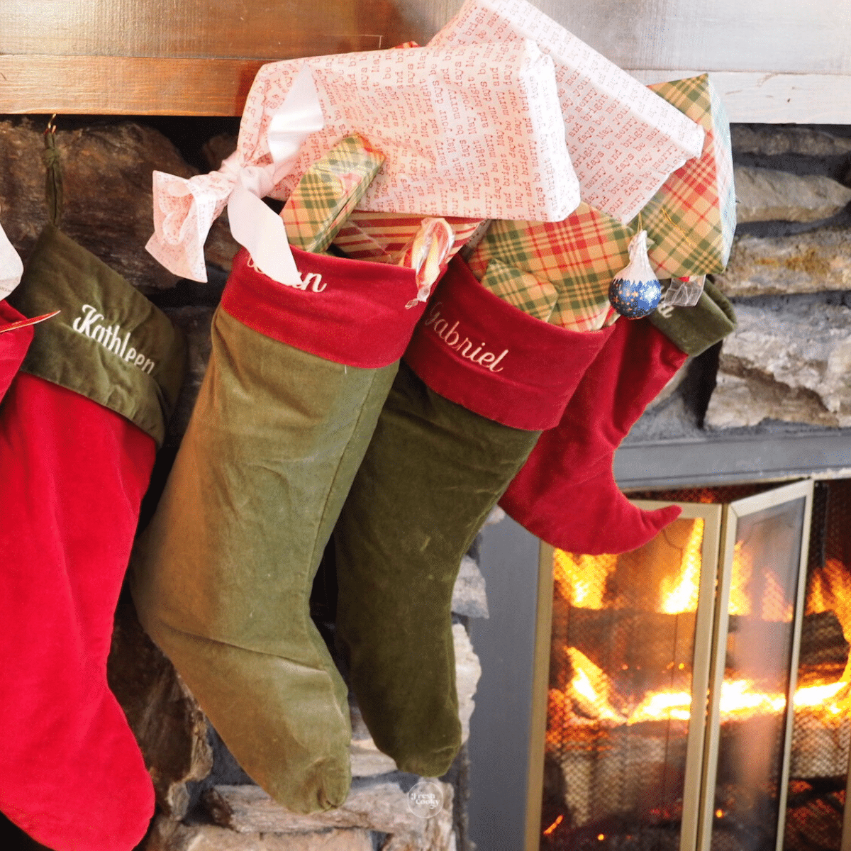 Stockings stuffed and hung on the mantel with a fire going.