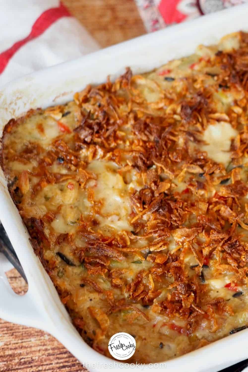 Close up image of chicken and wild rice casserole with crispy onions