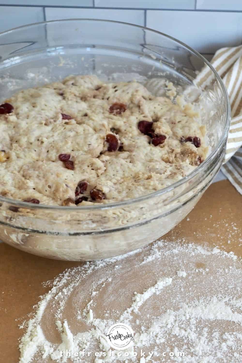 Risen dough overnight. Has fermented some and risen about double. Sitting in glass bowl with flour dusted parchment paper.