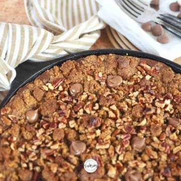 Facebook image portion of chocolate pumpkin graham crisp in cast iron skillet with tea towel tied to hot handle.