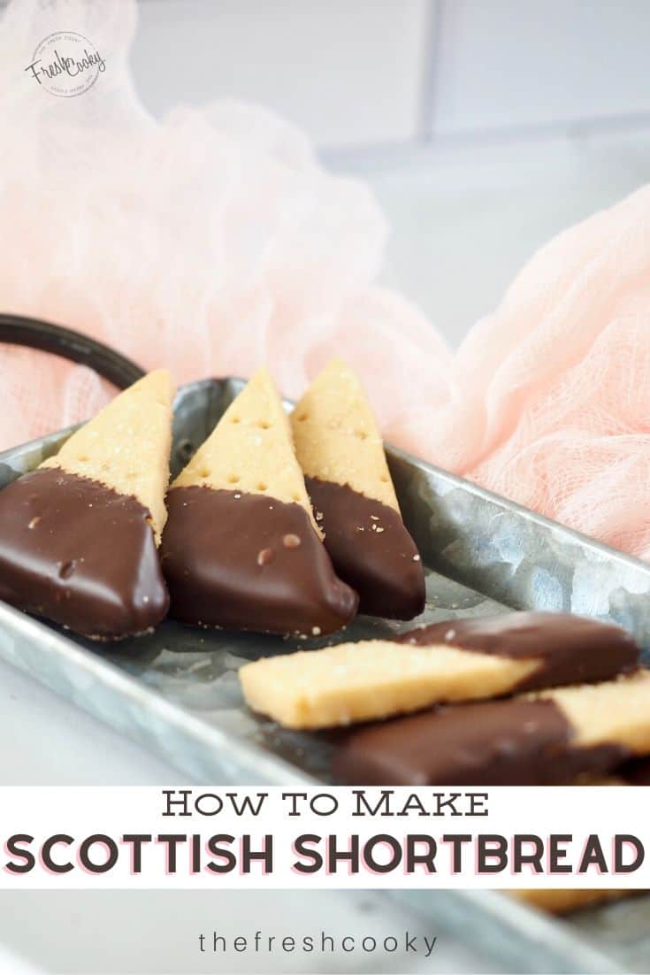 Pretty Wedge shaped Scottish shortbread cookies dipped in chocolate on a galvanized tray.