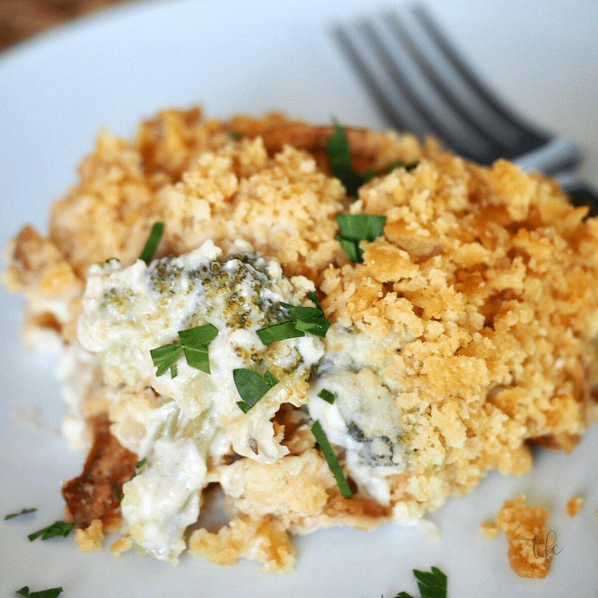 Chicken Divan on a plate with a fork, showing a buttery crumb topping.