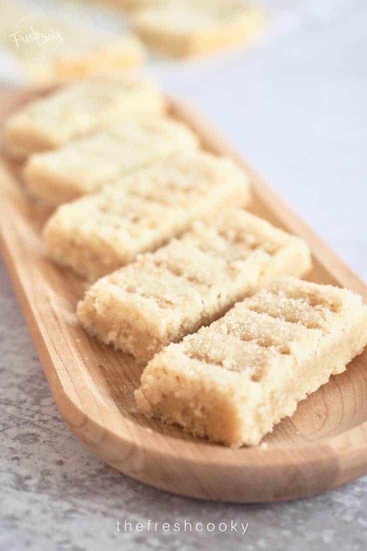Classic Shortbread Recipe with shortbread fingers sitting diagonally on a wooden tray.