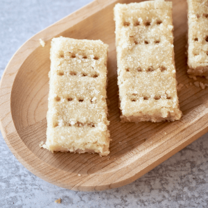 Classic Scotch shortbread fingers on wooden tray for serving.