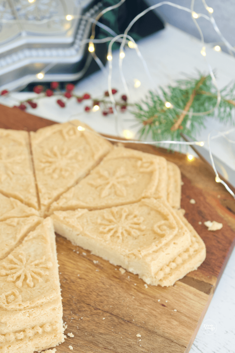 Baked and cooled molded Scotch shortbread recipe, turned onto cutting board and cut into triangles. 