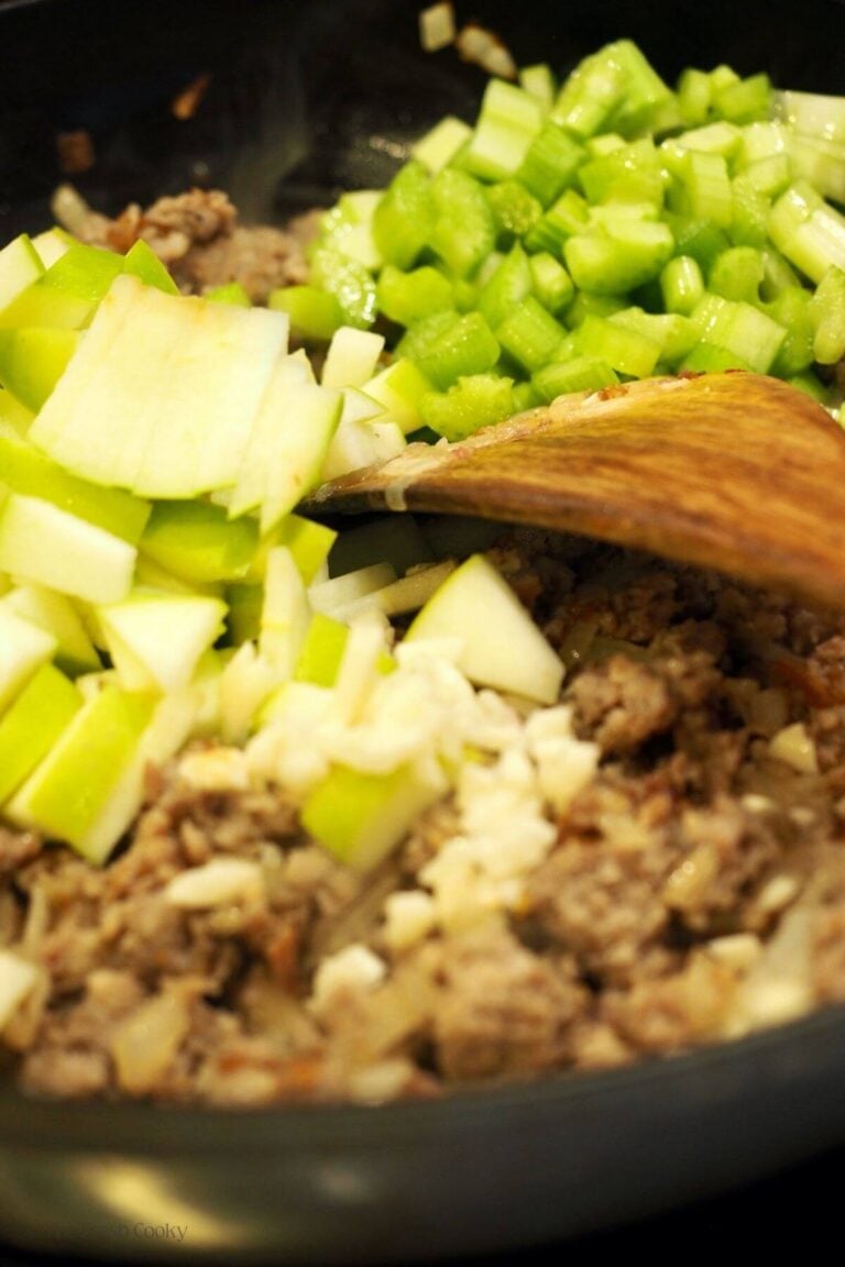 Stirring in apples and celery into stuffing.