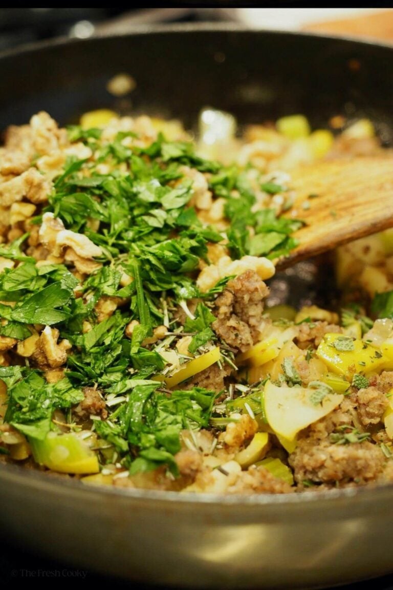 Mixing in fresh herbs and nuts into stuffing.