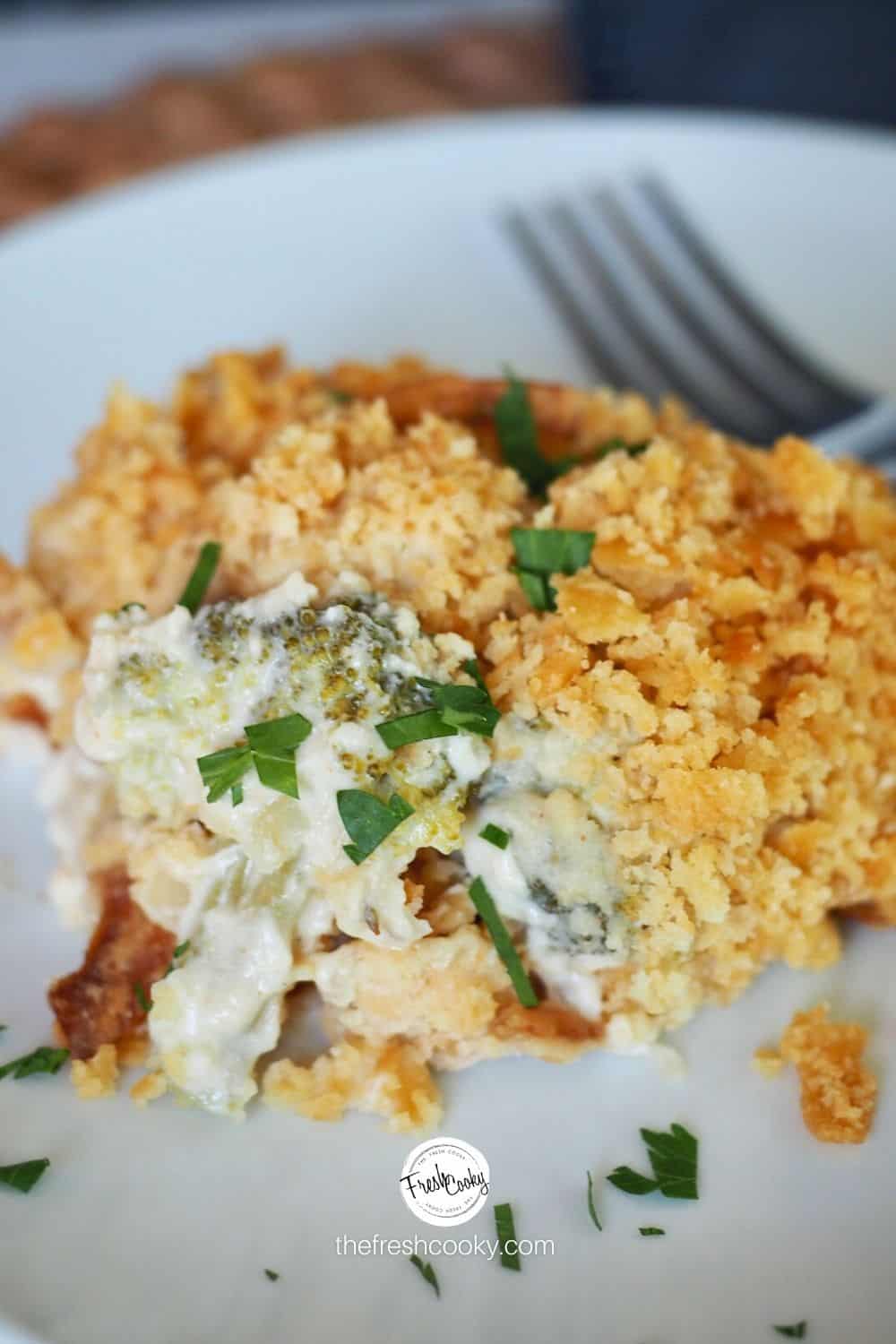 cracker topped turkey divan using leftovers on a white plate with a fork in the background.