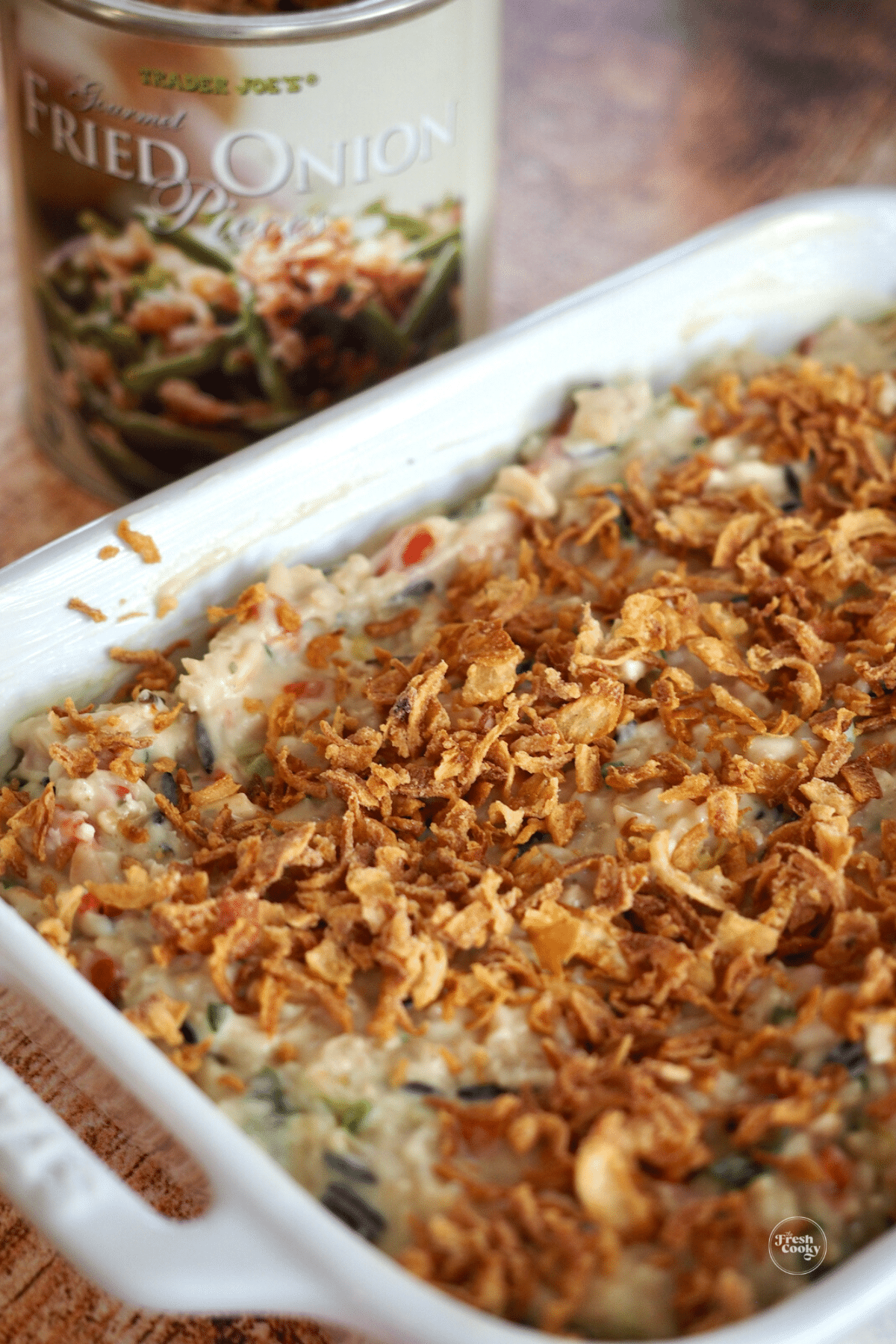 Easy Wild Rice Supreme in casserole dish with crispy onions behind.