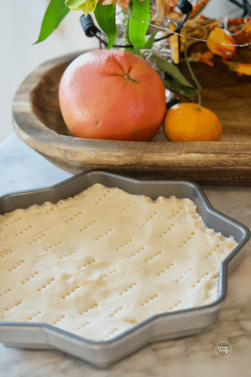 Shortbread dough pressed into snowflake cookie dough mold. 