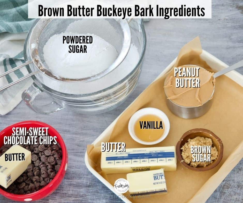 Ingredient shot for Buckeye Bars. Sifted powdered sugar, peanut butter, vanilla, butter, brown sugar, chocolate chips and more butter.