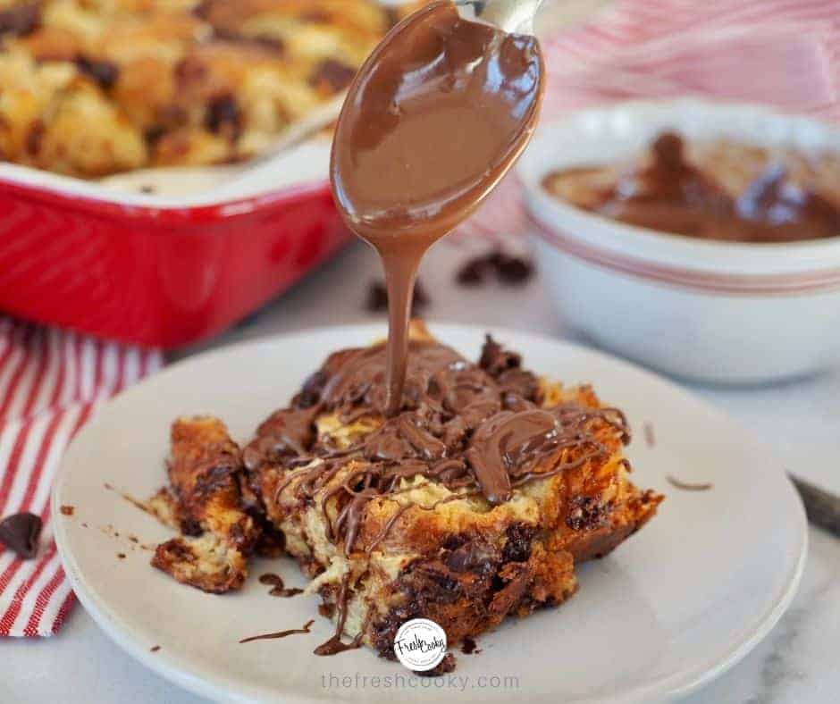 FB Image with spoon drizzling Nutella on a square of chocolate croissant french toast.