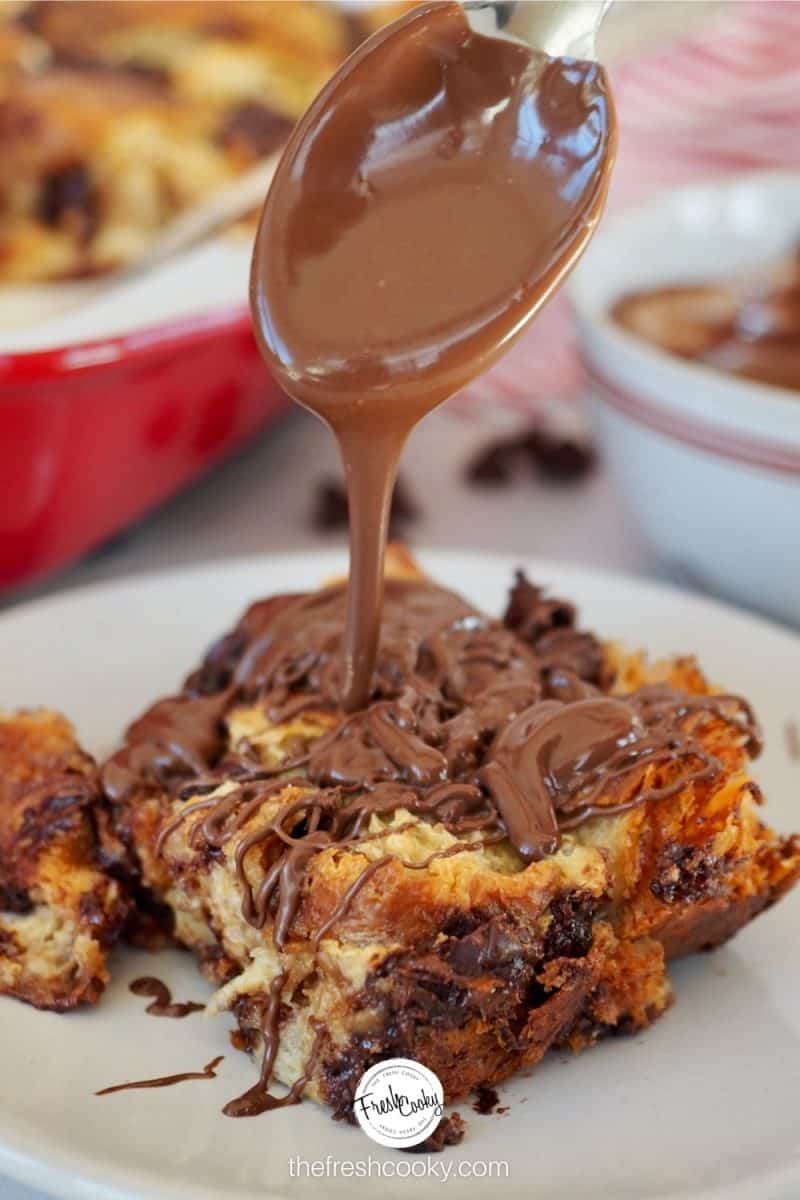 Spoon drizzling runny Nutella on top of a square of Croissant Chocolate Chip french toast