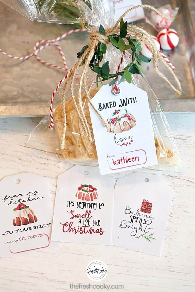 cello wrapped cookie tied with free gift tag that says, baked with love, along with three other free printable gift tags