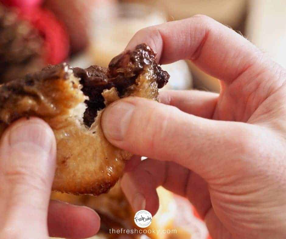 Facebook image for Chocolate Bread Recipe. Hands tearing a bread roll with oozing chocolate from the center.