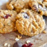 Image of stoneplate with 4 healthy gluten free breakfast cookies with almonds, cranberries and chocolate chip on plate, natural linen napkin under the plate.