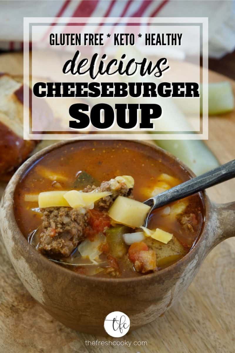 Pinterest image for healthy cheeseburger soup wiht image of bowl of soup with handle with ground beef, potatoes, pickles in the background.