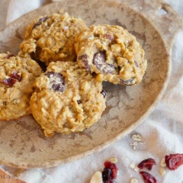 Four breakfast cookies on a plate.