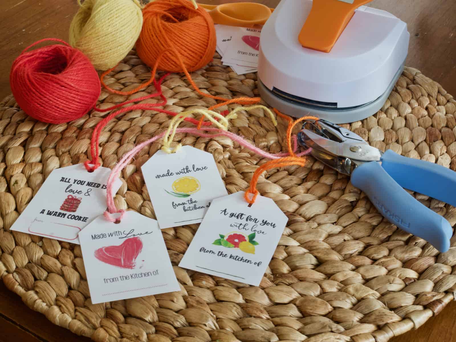 Facebook image of 4 different from the kitchen of gift tags with a space to write your name with colored twin, hole punch and tag punch in background.
