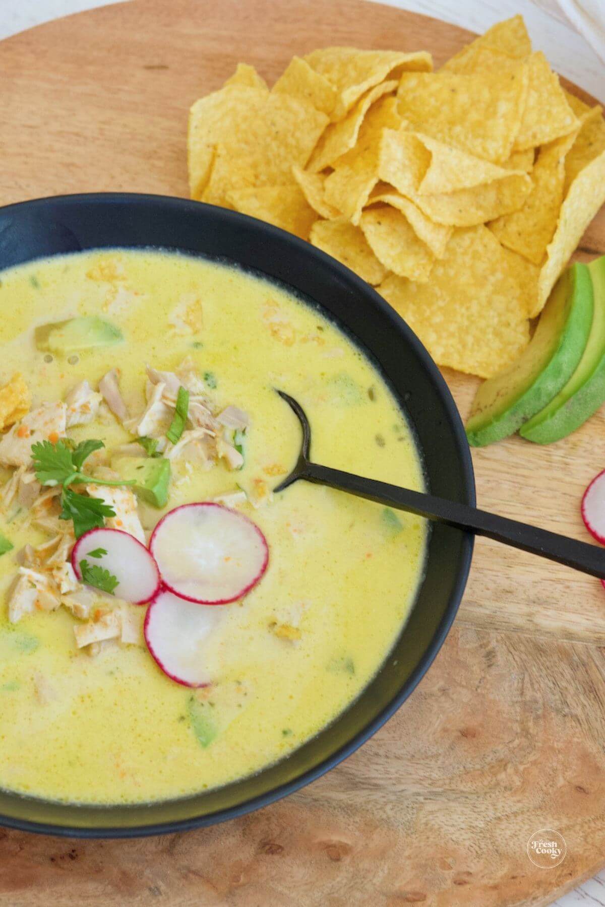 Bowl full of light and creamy chicken poblano soup recipe.