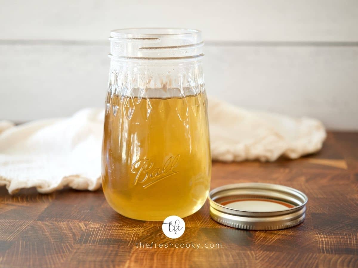 cooling mason jar of golden cane sugar simple syrup on butcher block
