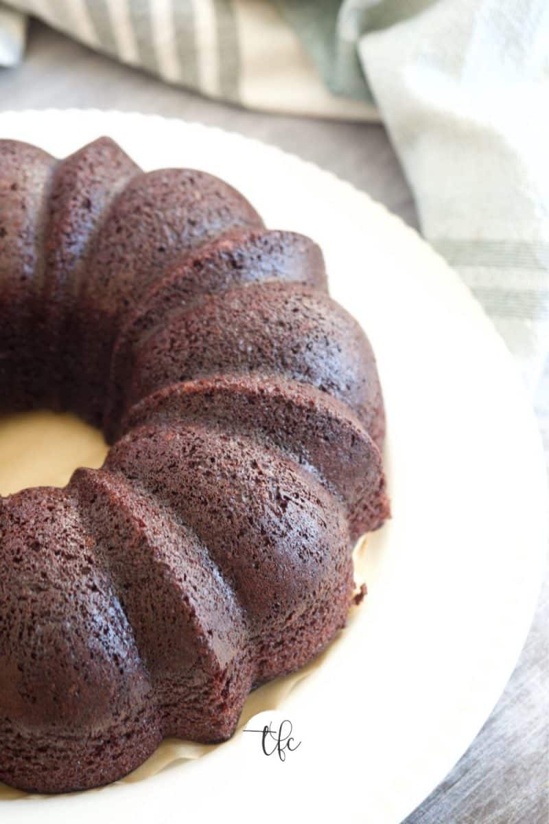 Easy Chocolate Loaf Cake made in bundt pan, unfrosted chocolate cake on white plate