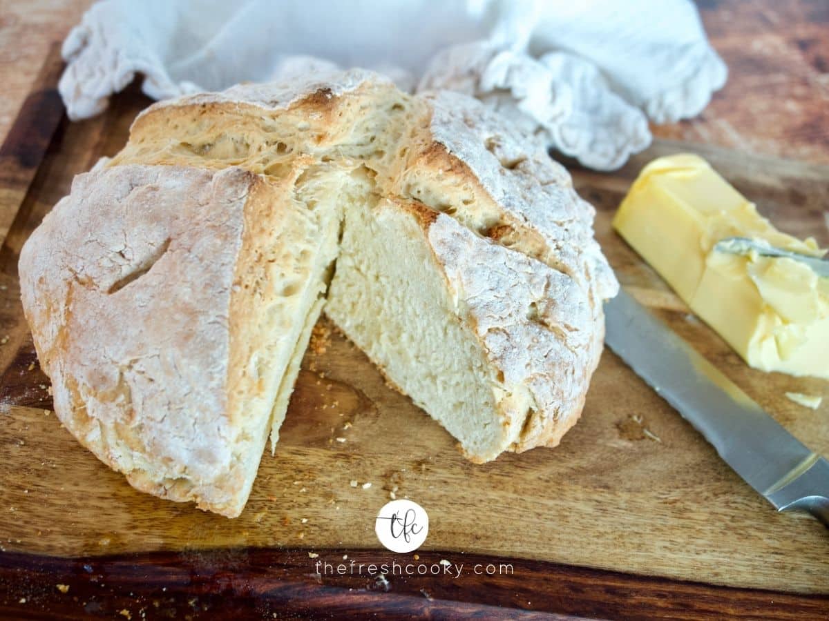 Facebook image for 4 ingredient Irish soda bread with wedge removed and irish butter on side.