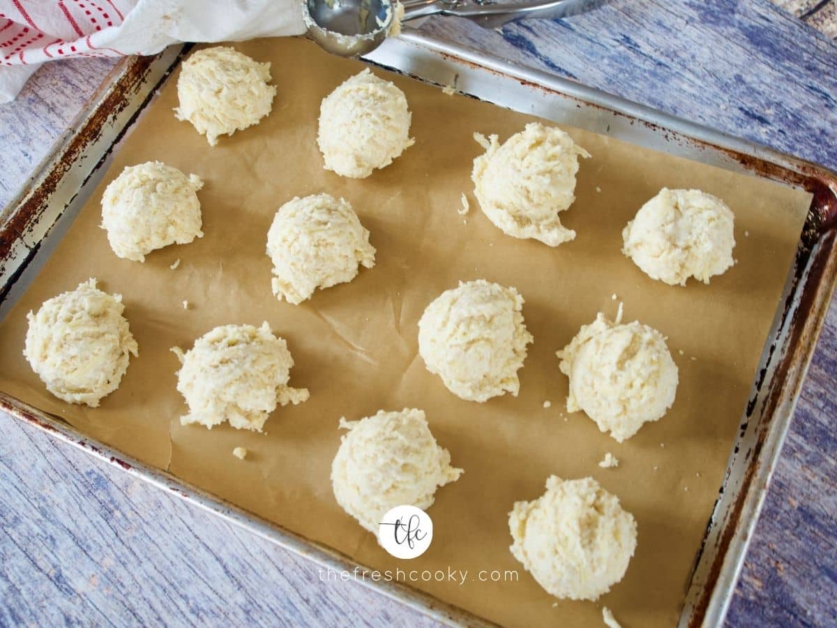 scooped batter onto parchment lined baking sheet for red lobster cheddar biscuits.
