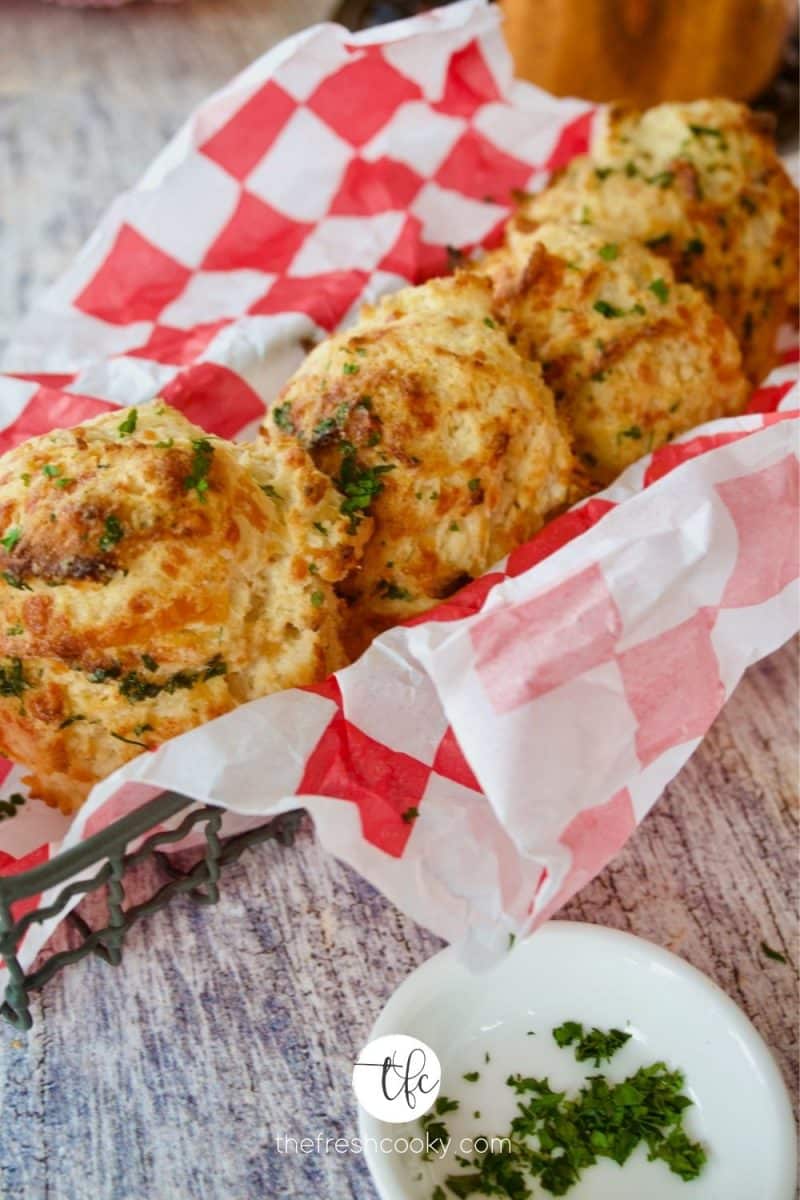 basket of red lobster cheddar biscuits in red checked paper.