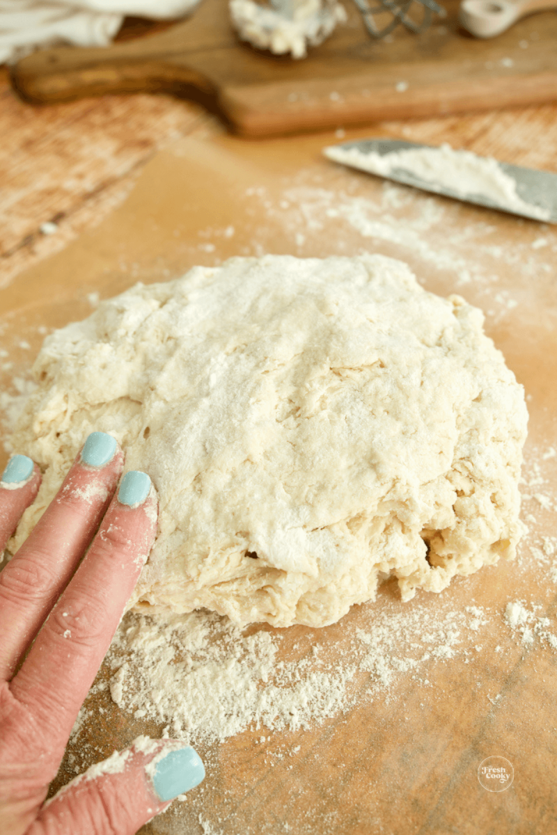 Pat bread dough into a round loaf. 
