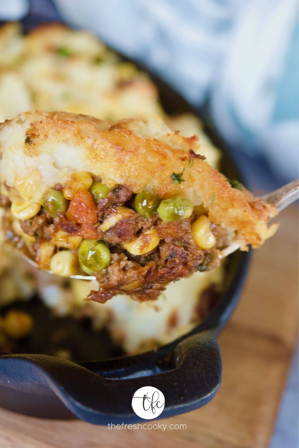 Skillet Shepherd's Pie with spoonful of meaty pie being scooped up.