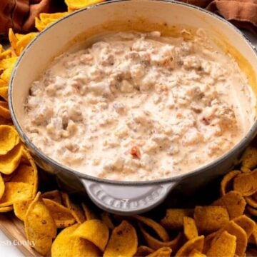 Sausage dip in pan with chips around.