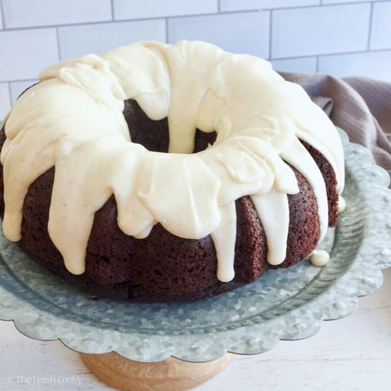 Vanilla glaze poured over a chocolate bundt cake.