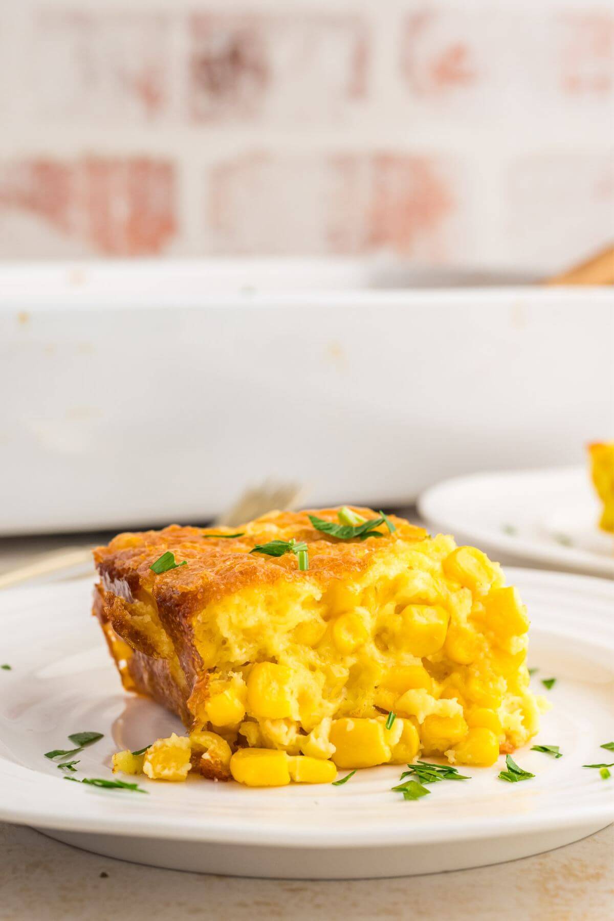 Plate with serving of corn pudding on the plate.