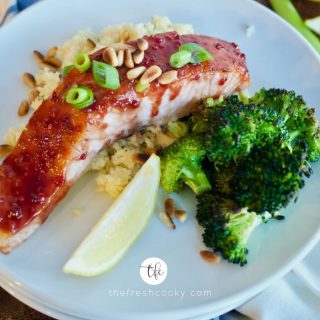 Facebook image of raspberry glazed salmon fillet sitting on top of couscous with roasted broccoli.