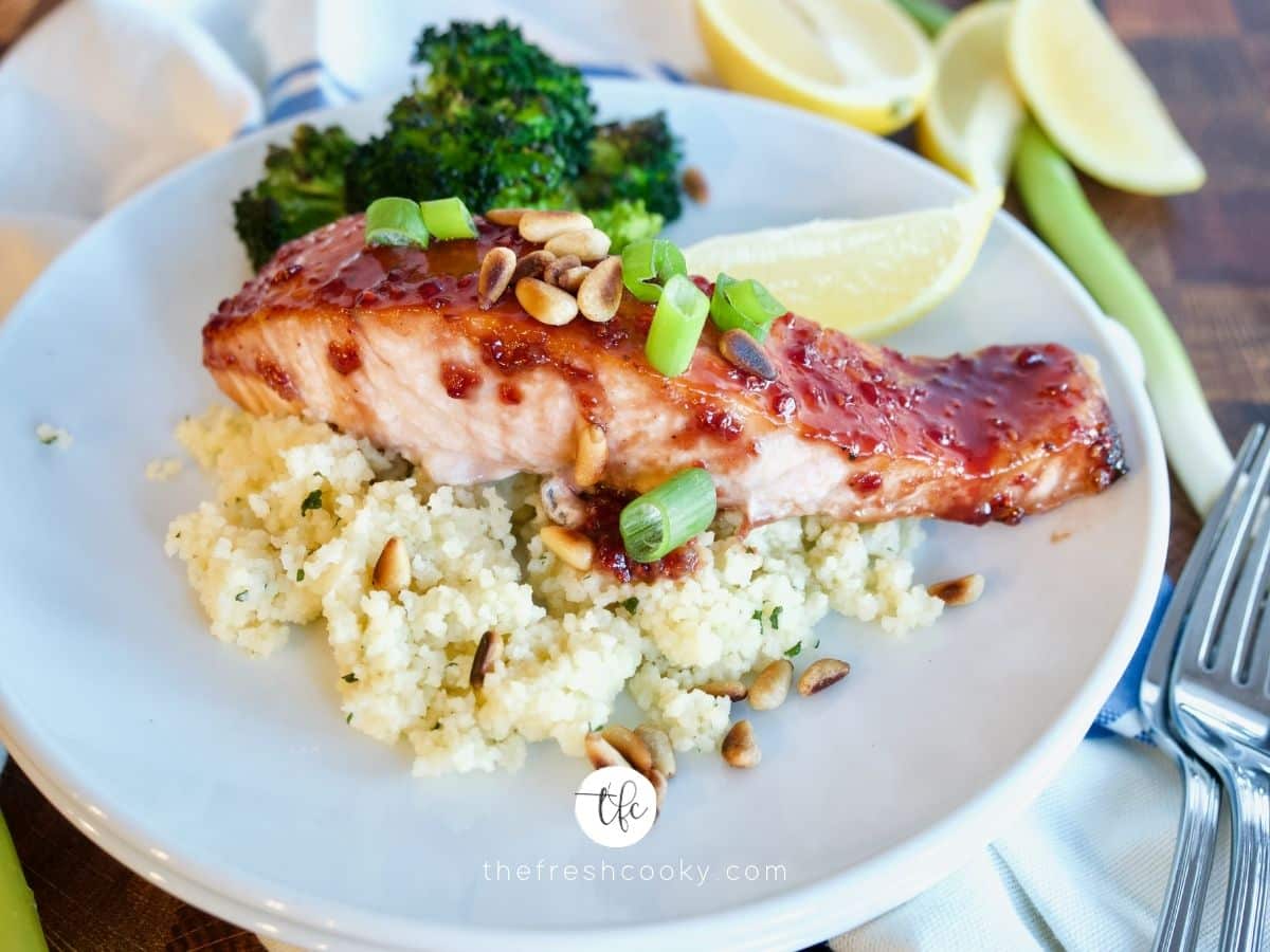 facebook image for raspberry glazed salmon plated on top of a bed of couscous with roasted broccoli.