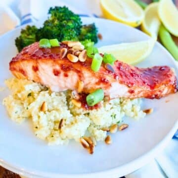 Raspberry glazed salmon on a bed of couscous with lemon.