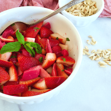 Strawberry Rhubarb Salad with dressing and slivered almonds.